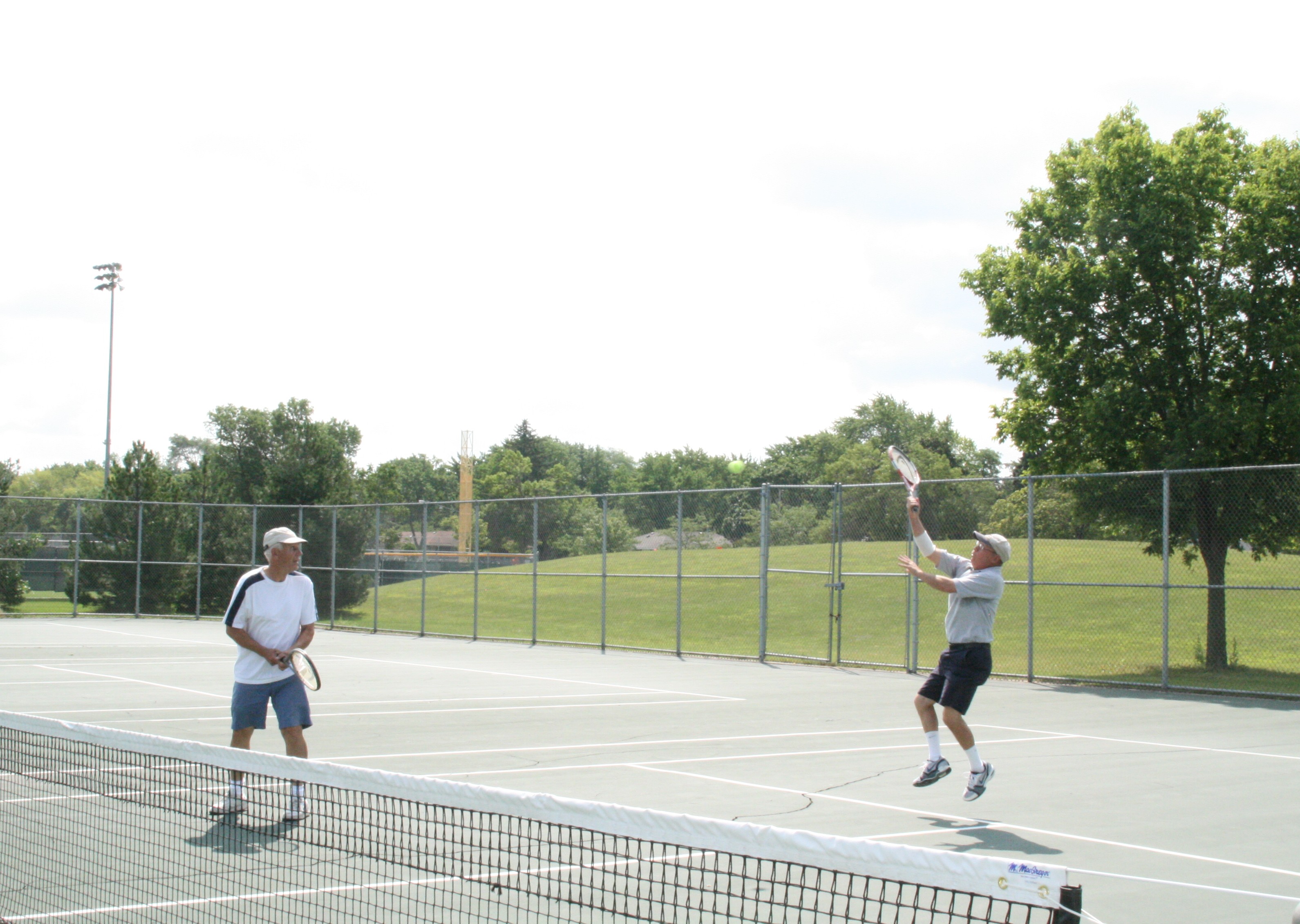 Two guys playing tennis
