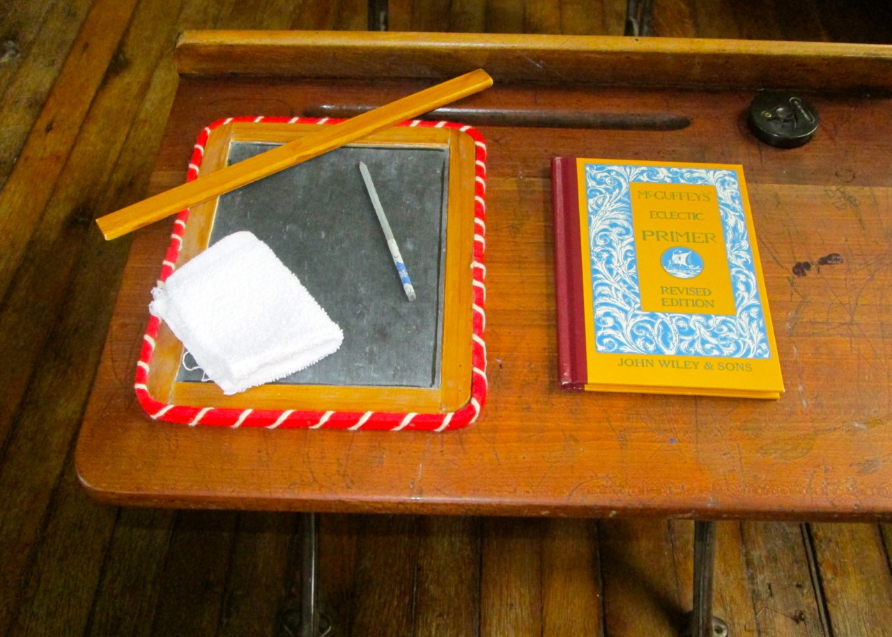 One Room Schoolhouse desk, pencil, book, chalkboard