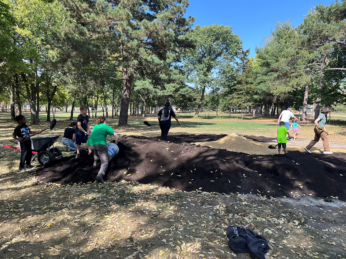 Volunteers preparing the Indigenous garden compost and gravel_3