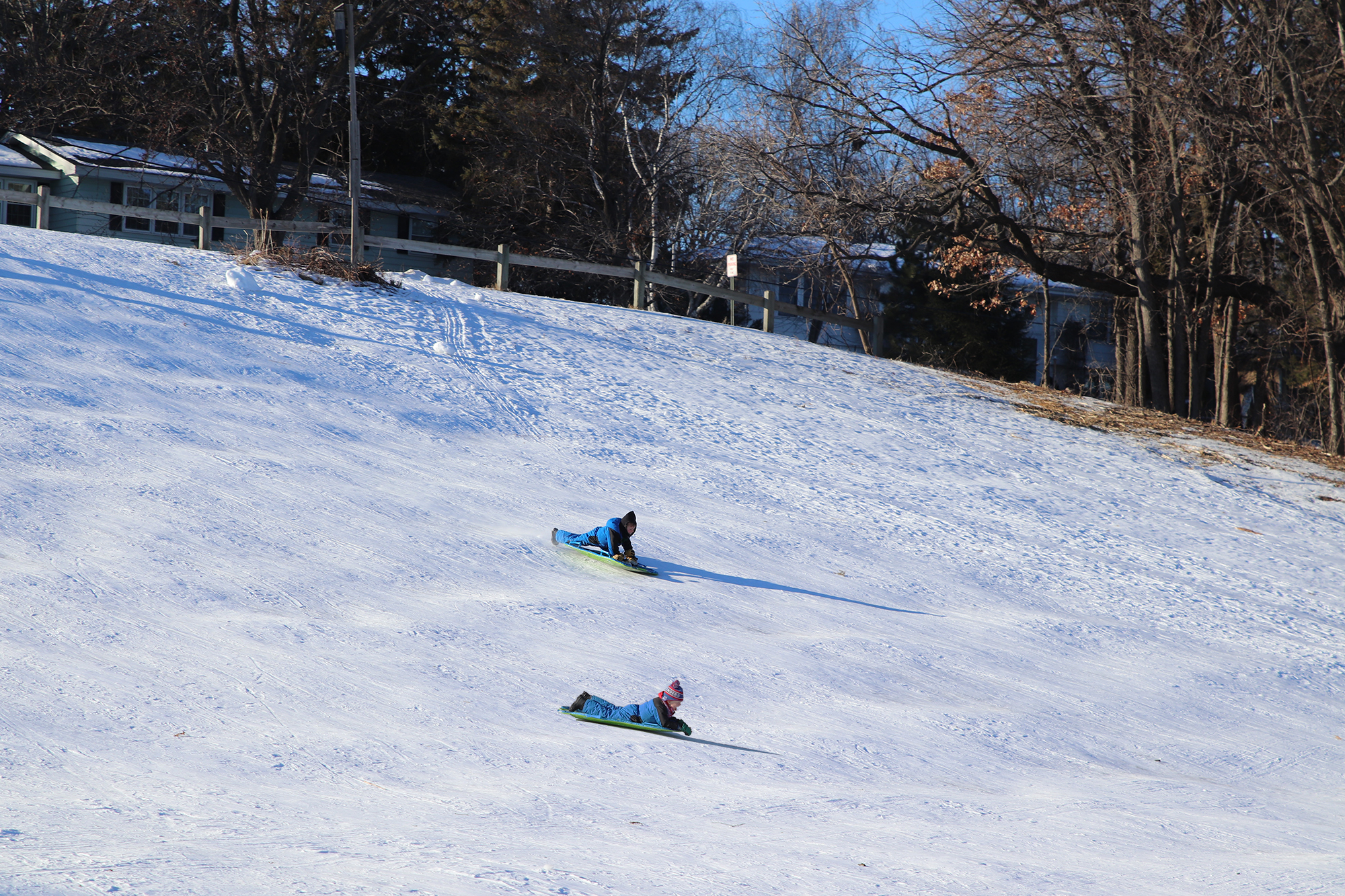 Two kids sledding at Brookside Park