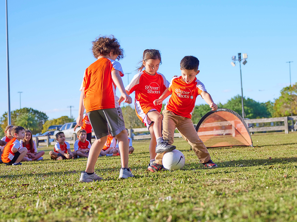 Soccer Shots three kids playing outdoors