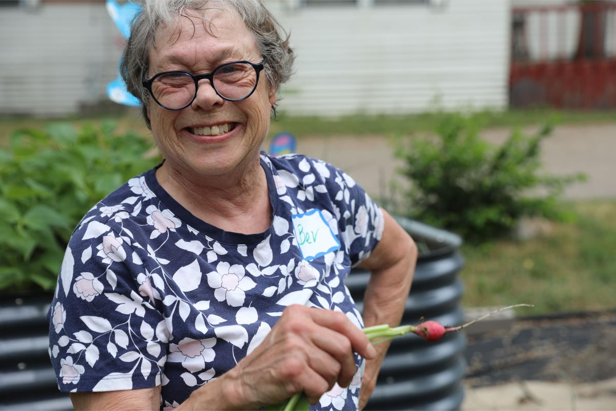 Bev smiling with a radish