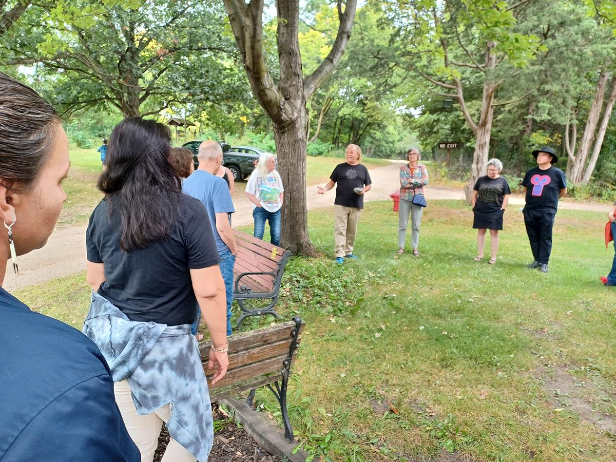 Ring of Dakota native people preparing to work on the Indigenous Plant Arboretum