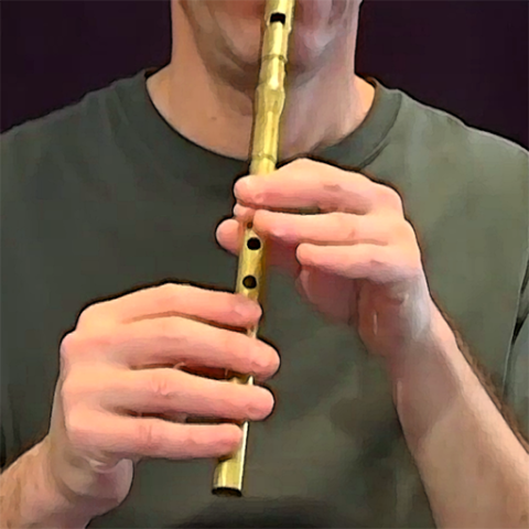 Man playing a tin whistle musical instrument