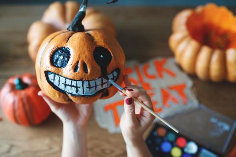 Woman painting pumpkins